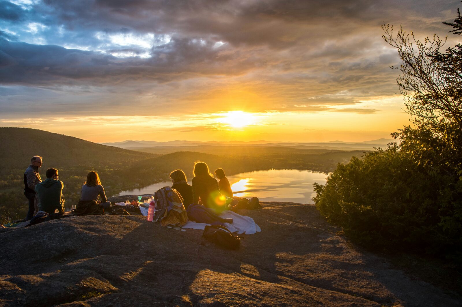 Friends watching the sunset over a valley