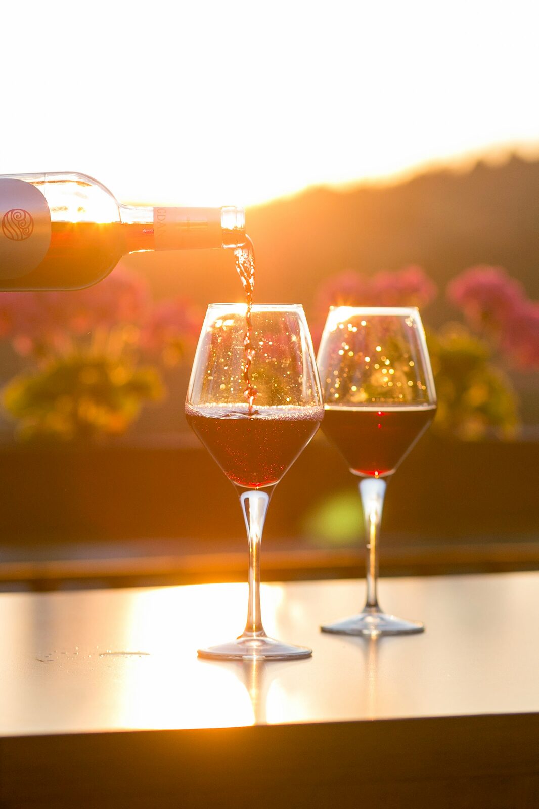 Wine being poured at sunset