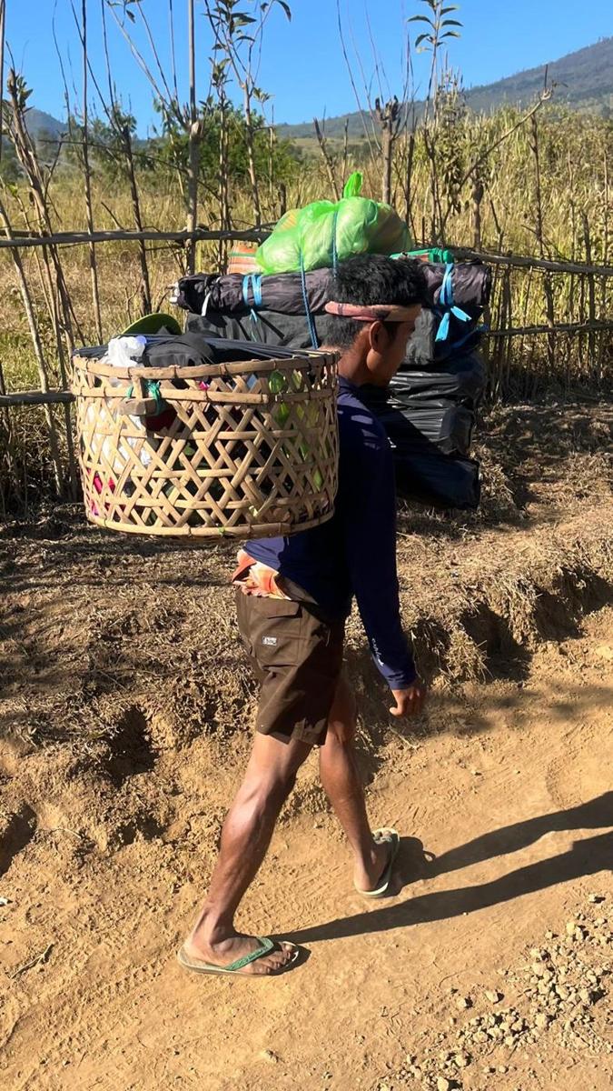 A porter carrying the camp